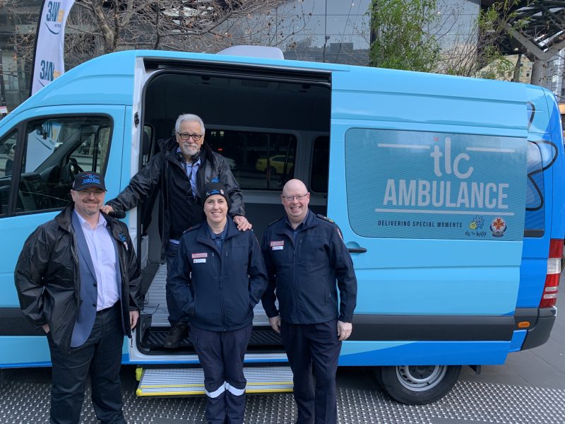 TLC for Kids CEO Tim Conolon, 3AW's Neil Mitchell, Ambulance Victoria paramedic Jemima Tawse and Ambulance Victoria CEO Associate Professor Tony Walker standing in front of the TLC Ambulance.