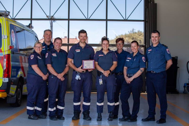 AV - The Rochester team holding the new branch plaque
