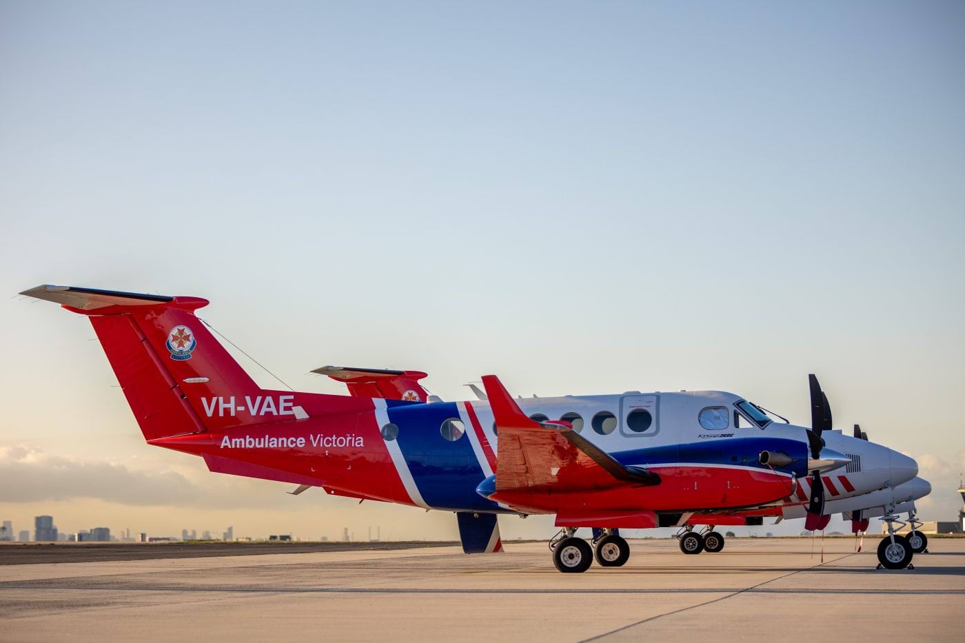 Photo shows a new Ambulance Victoria fixed wing aircraft parked at an airfield.
