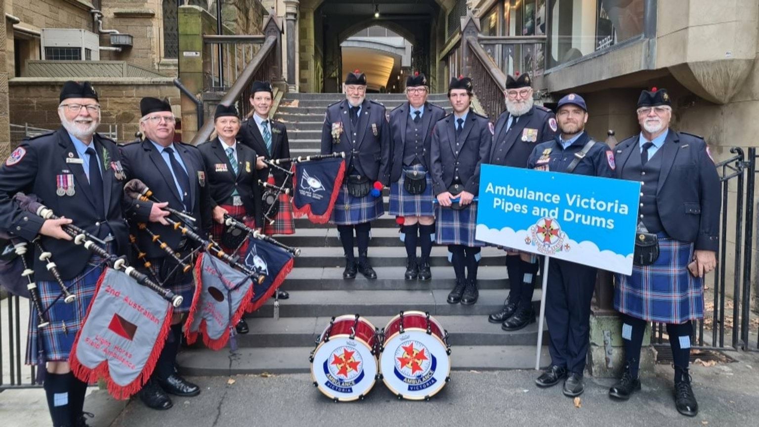 A group of people wearing kilts and holding instruments.
