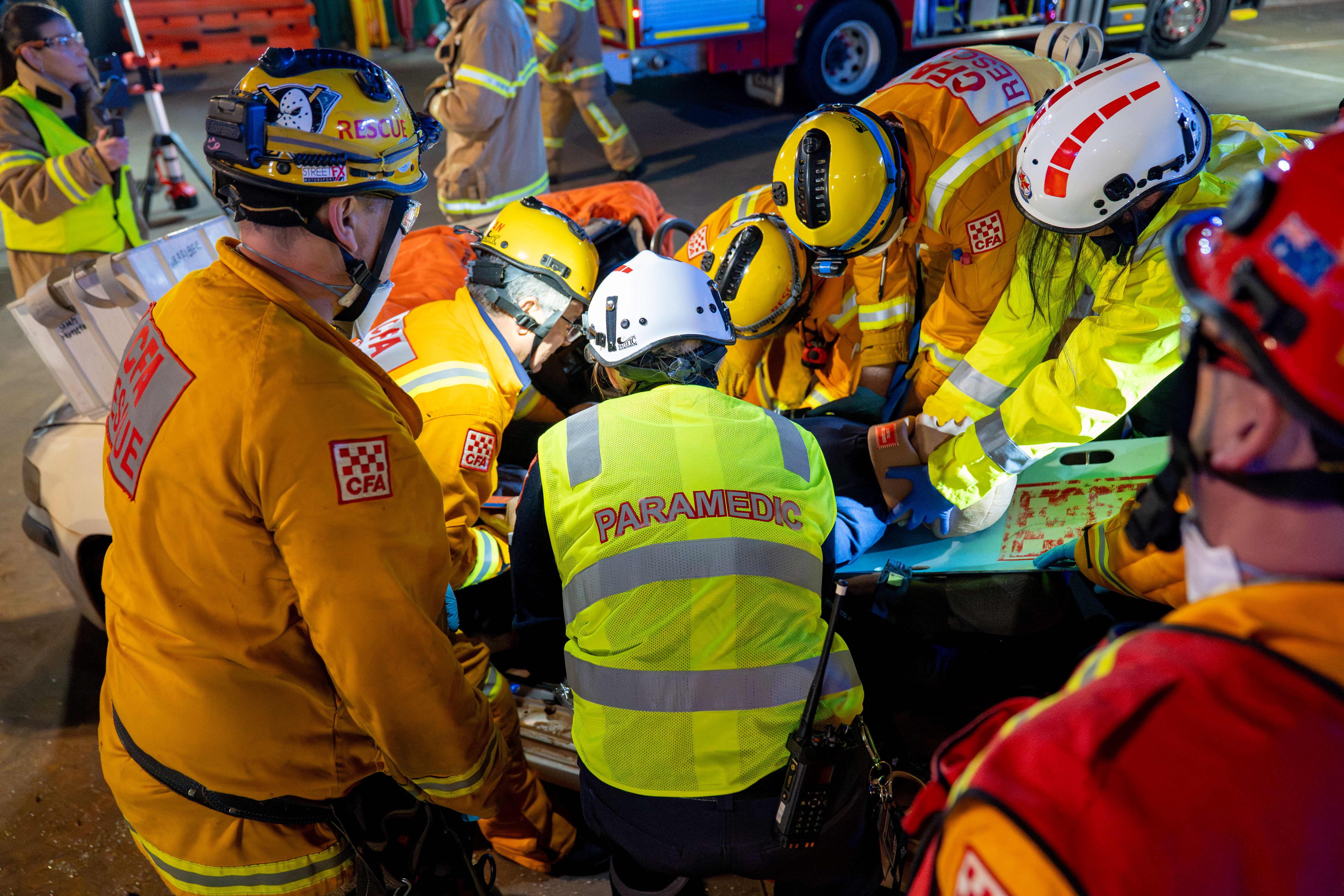 Paramedics and CFA members work to extricate a mannequin from a vehicle.