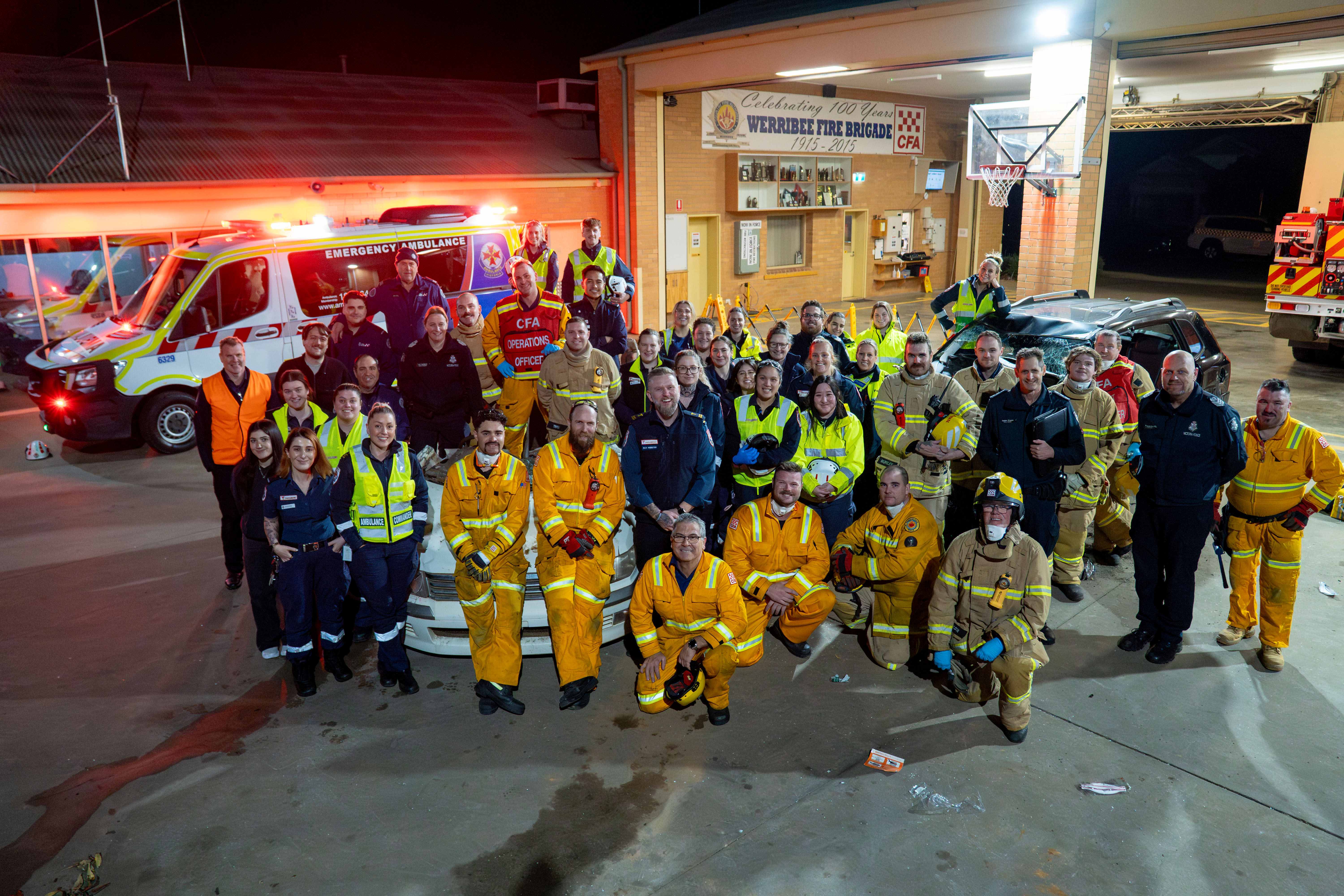 A group photo of first responders. It is night.