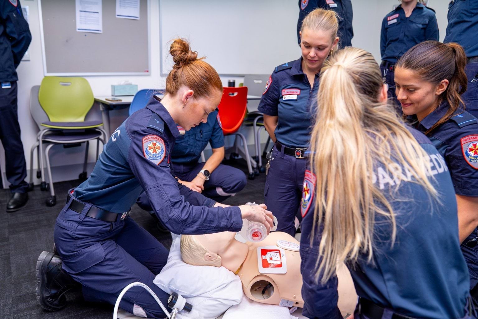A group of women paramedics are training their skills with a manikin.