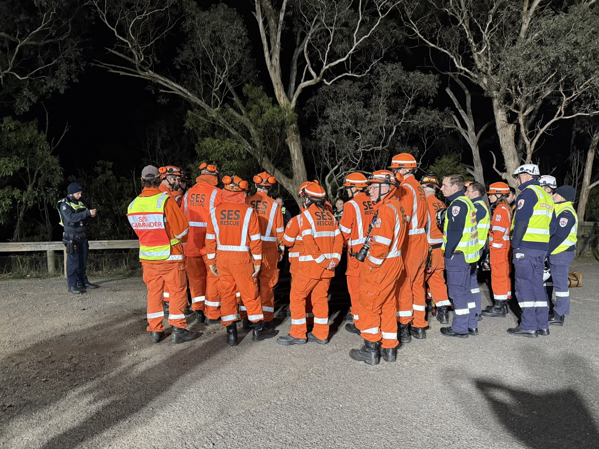 A group of police, SES volunteers and Ambulance Victoria paramedics gathered.