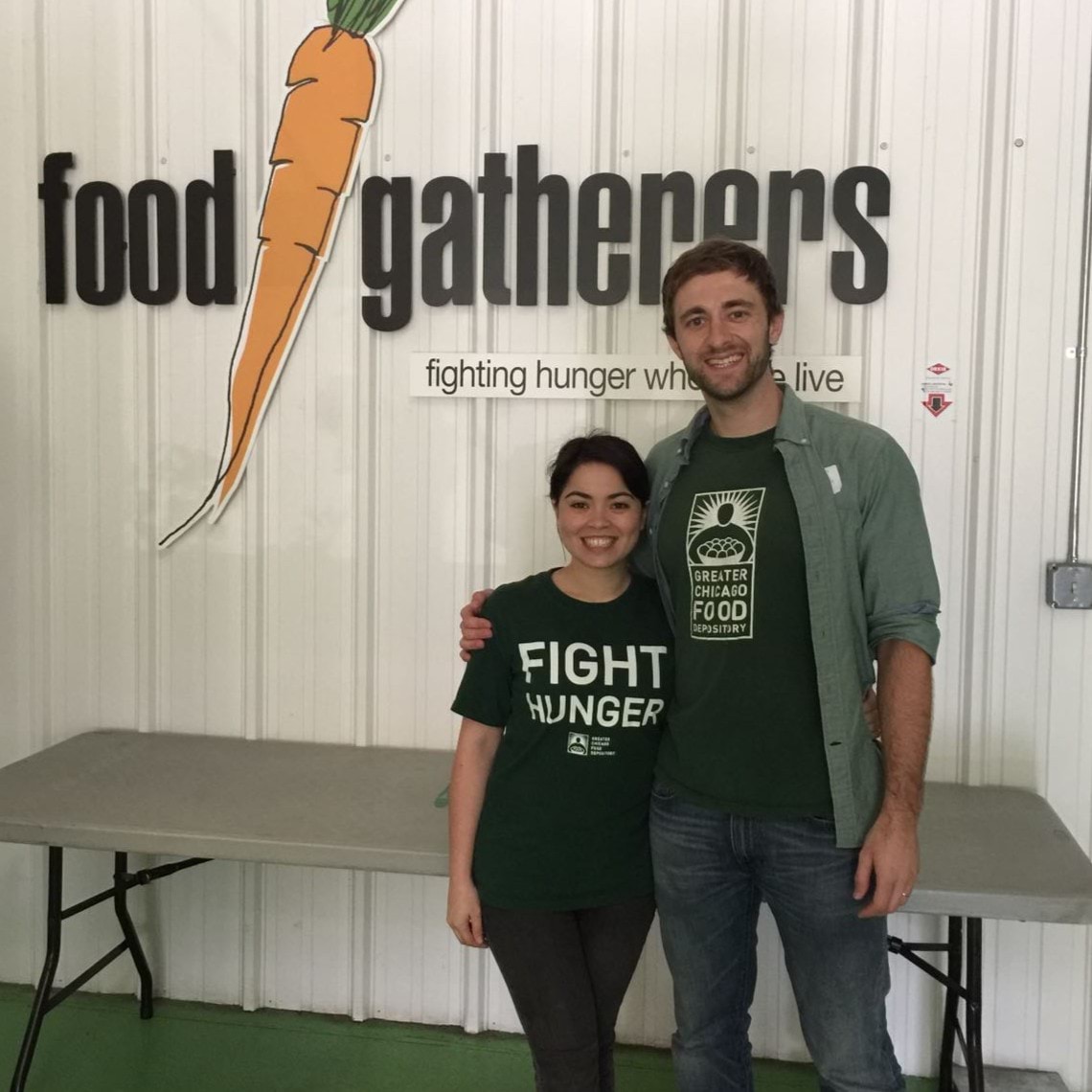 A man and woman wear Fight Hunger t-shirts.