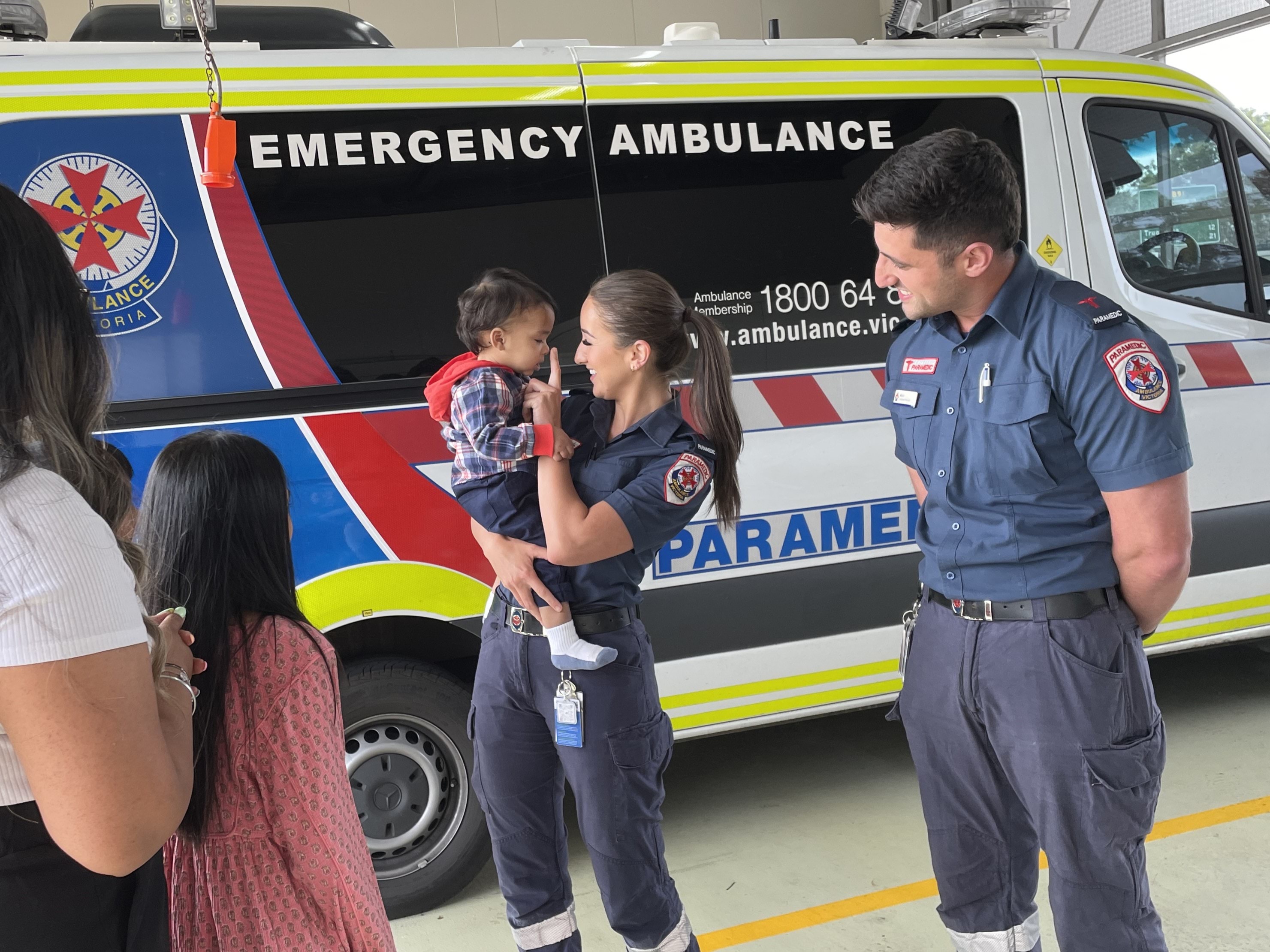 A paramedic plays with a one year old boy.