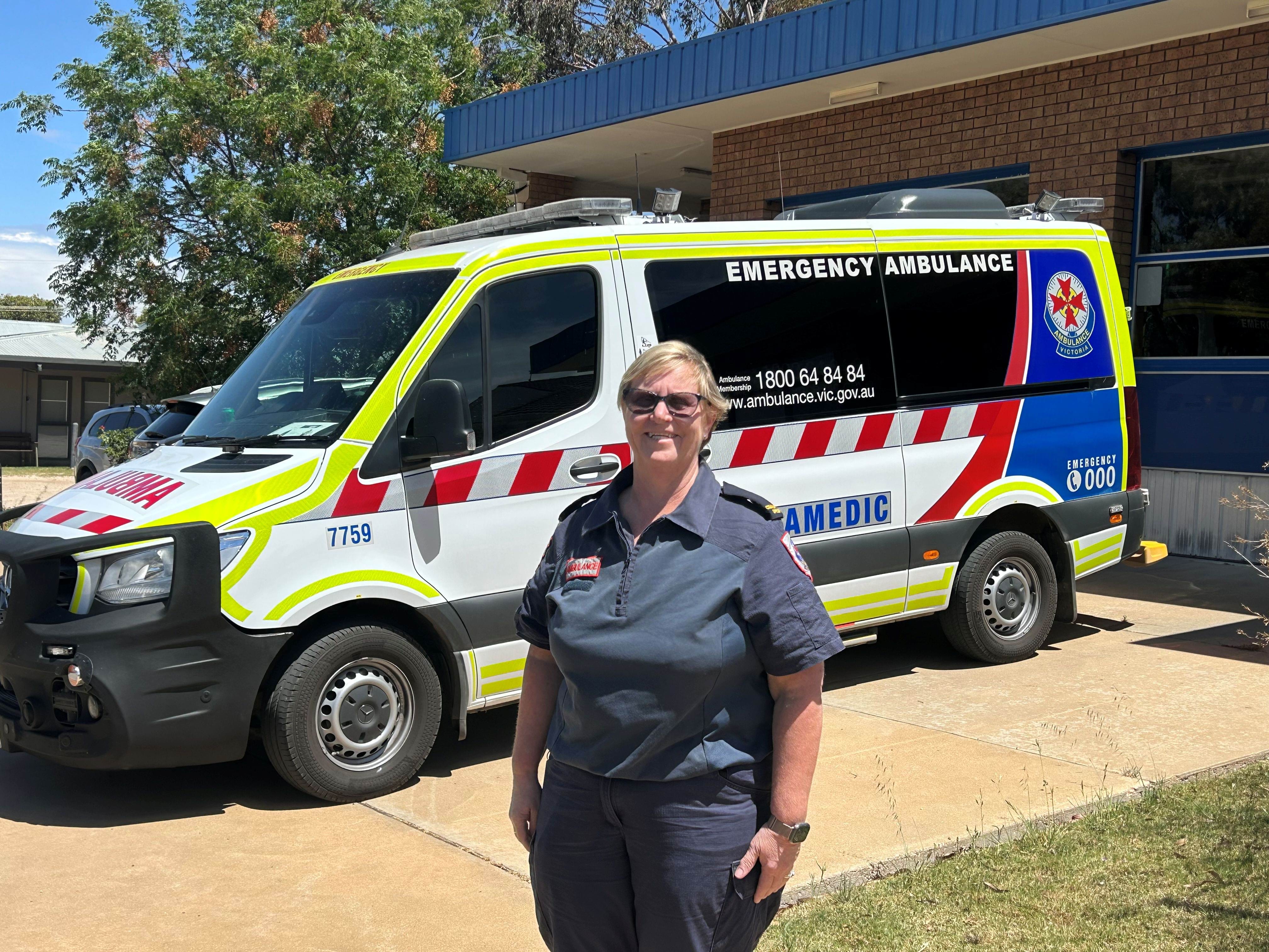 A woman in Ambulance Victoria uniform in front of an ambulance.