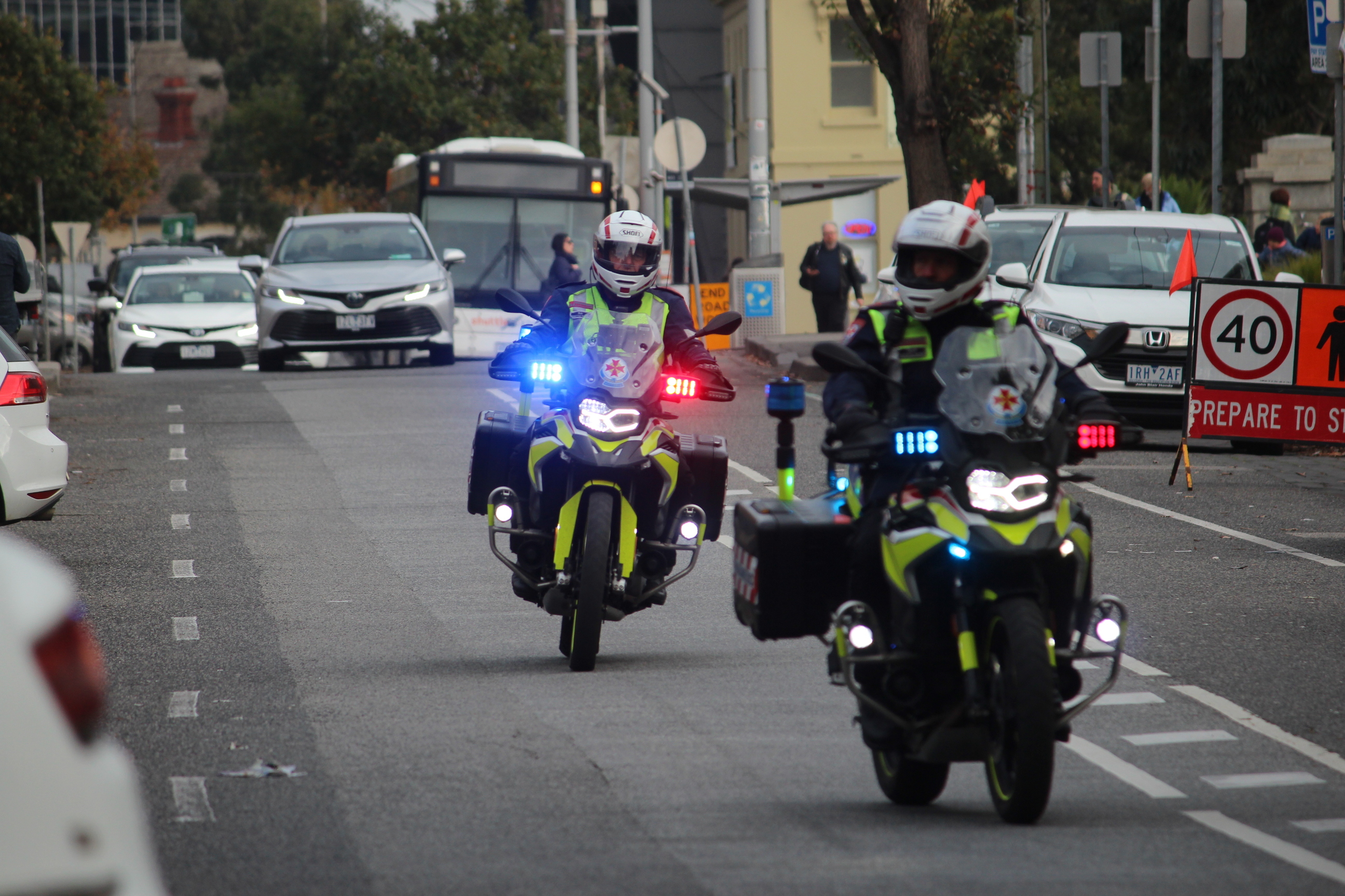 Two motorcycle paramedics riding on the road.