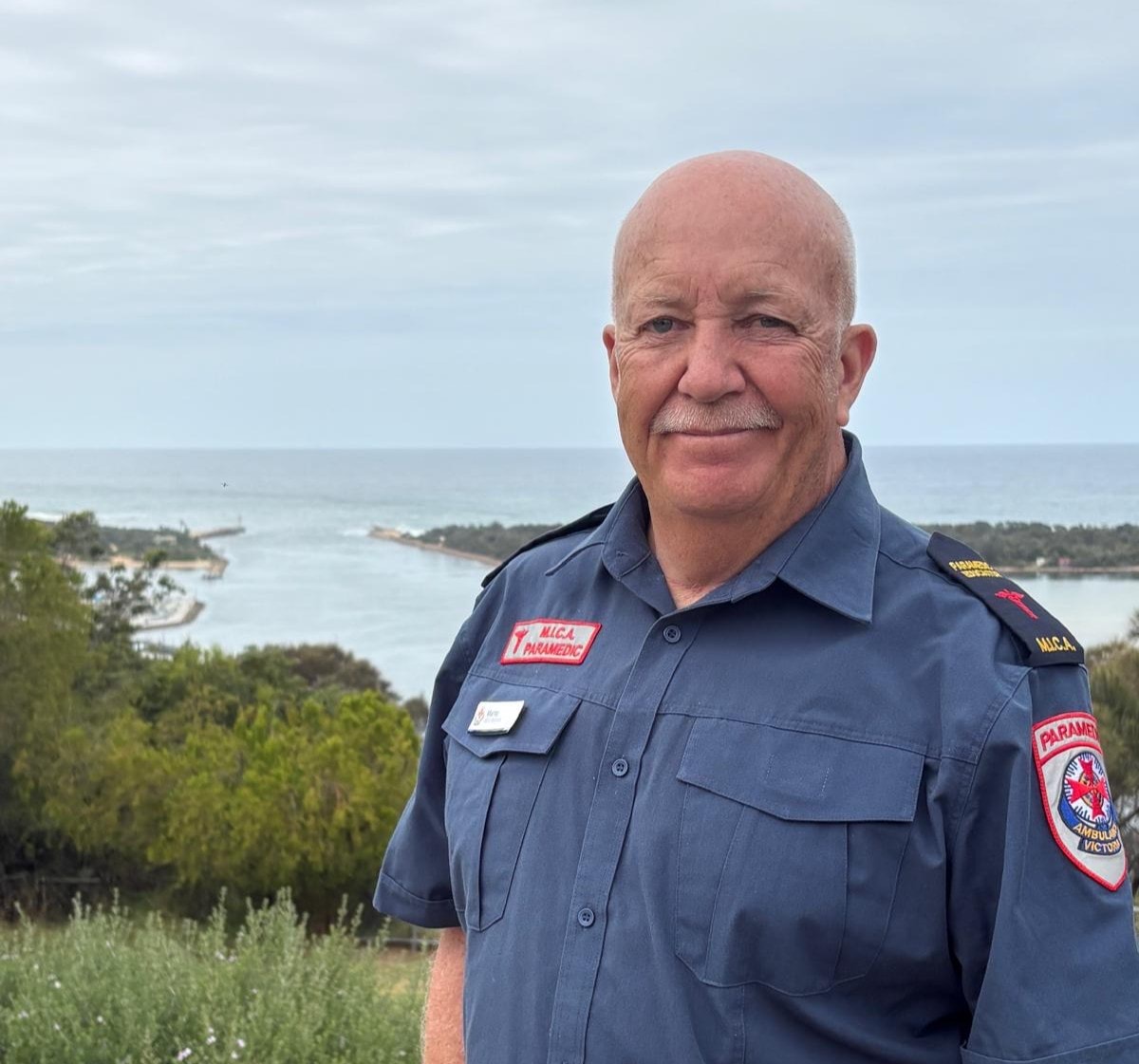 A MICA paramedic in front of the ocean.