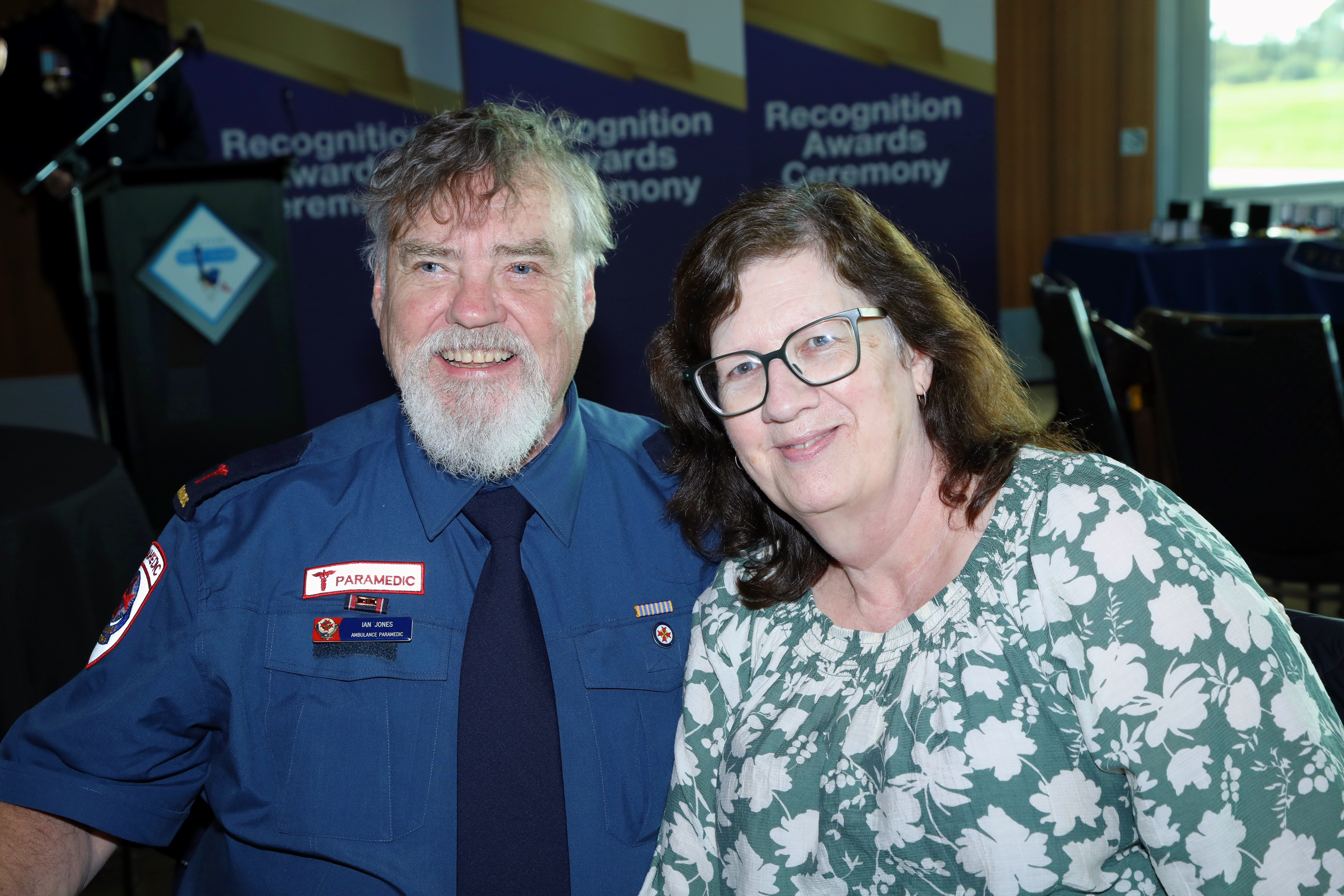 A paramedic and a woman in casual clothes.