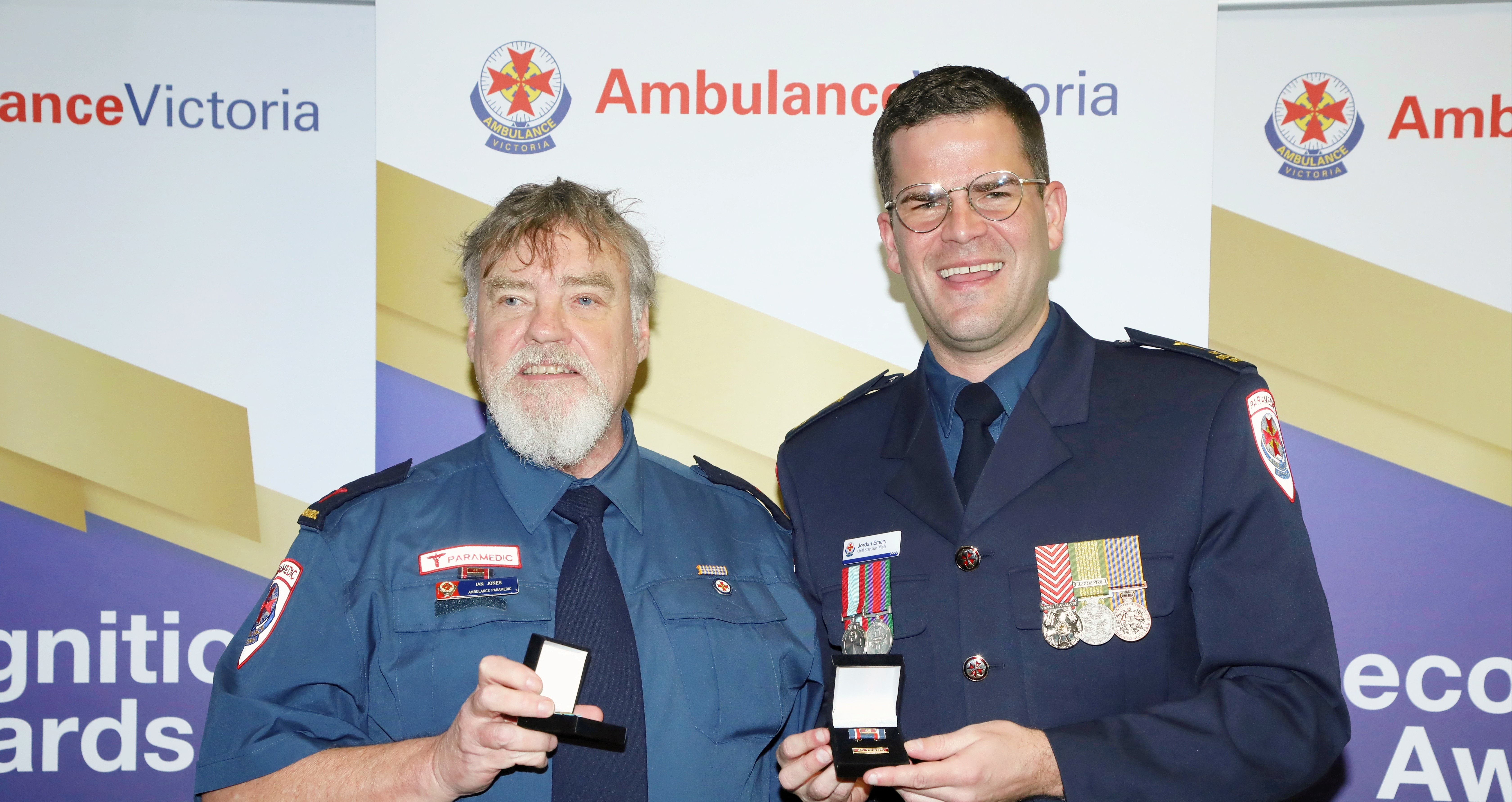 Two Ambulance Victoria paramedics at an awards event.