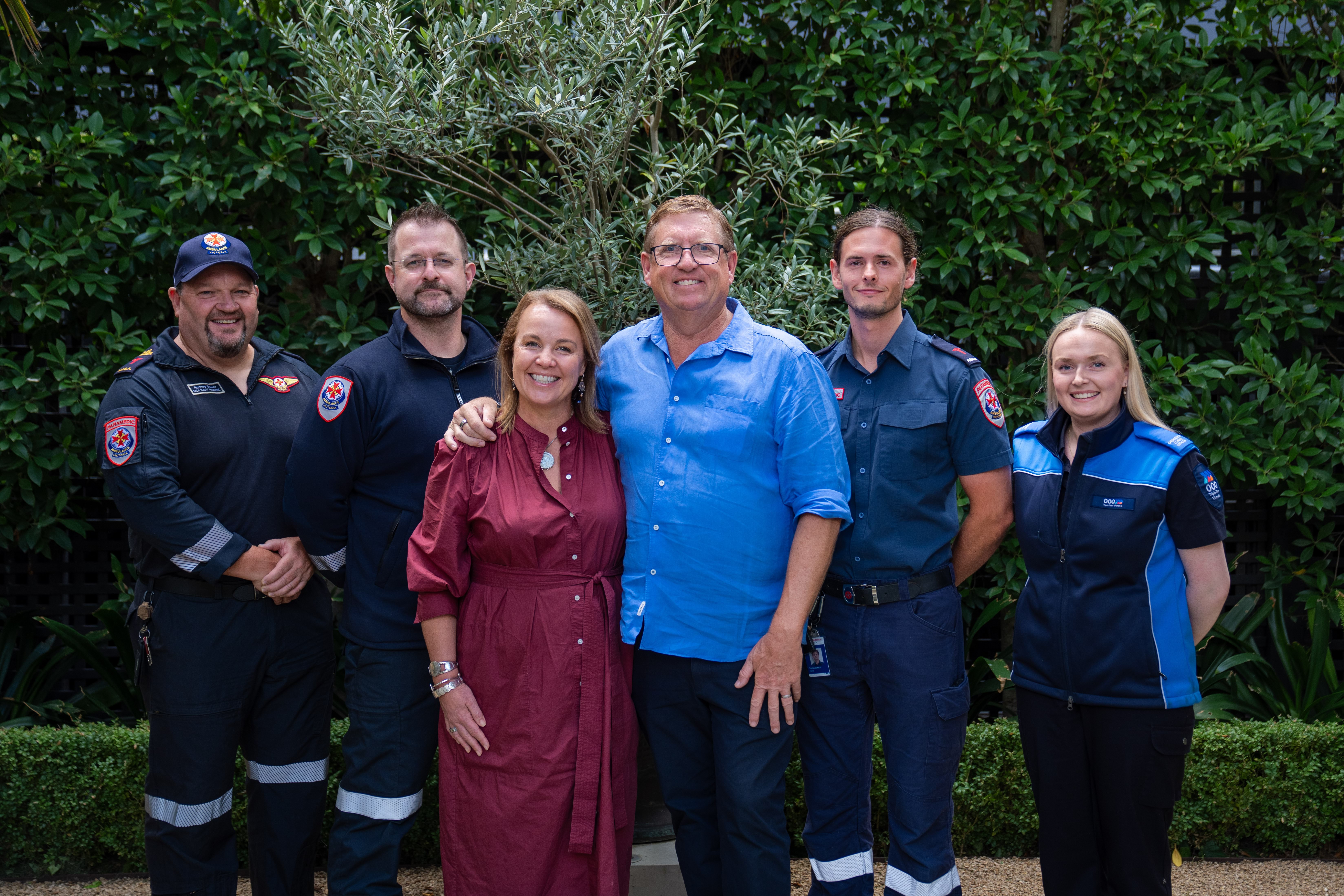 A group photo with Ambulance Victoria paramedics, a Triple Zero Victoria call taker and two people in casual clothes.