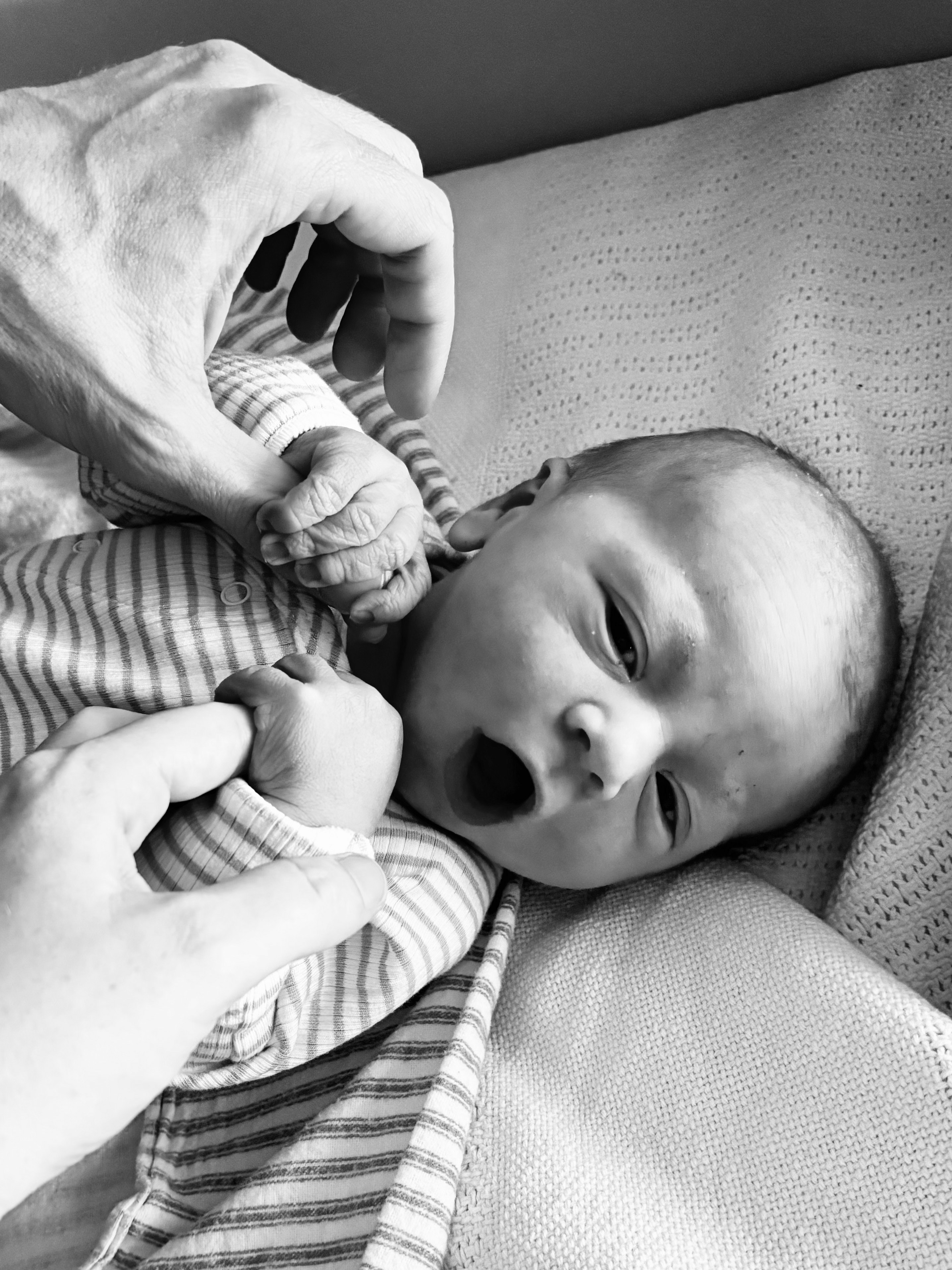 A black and white photo of a newborn baby.