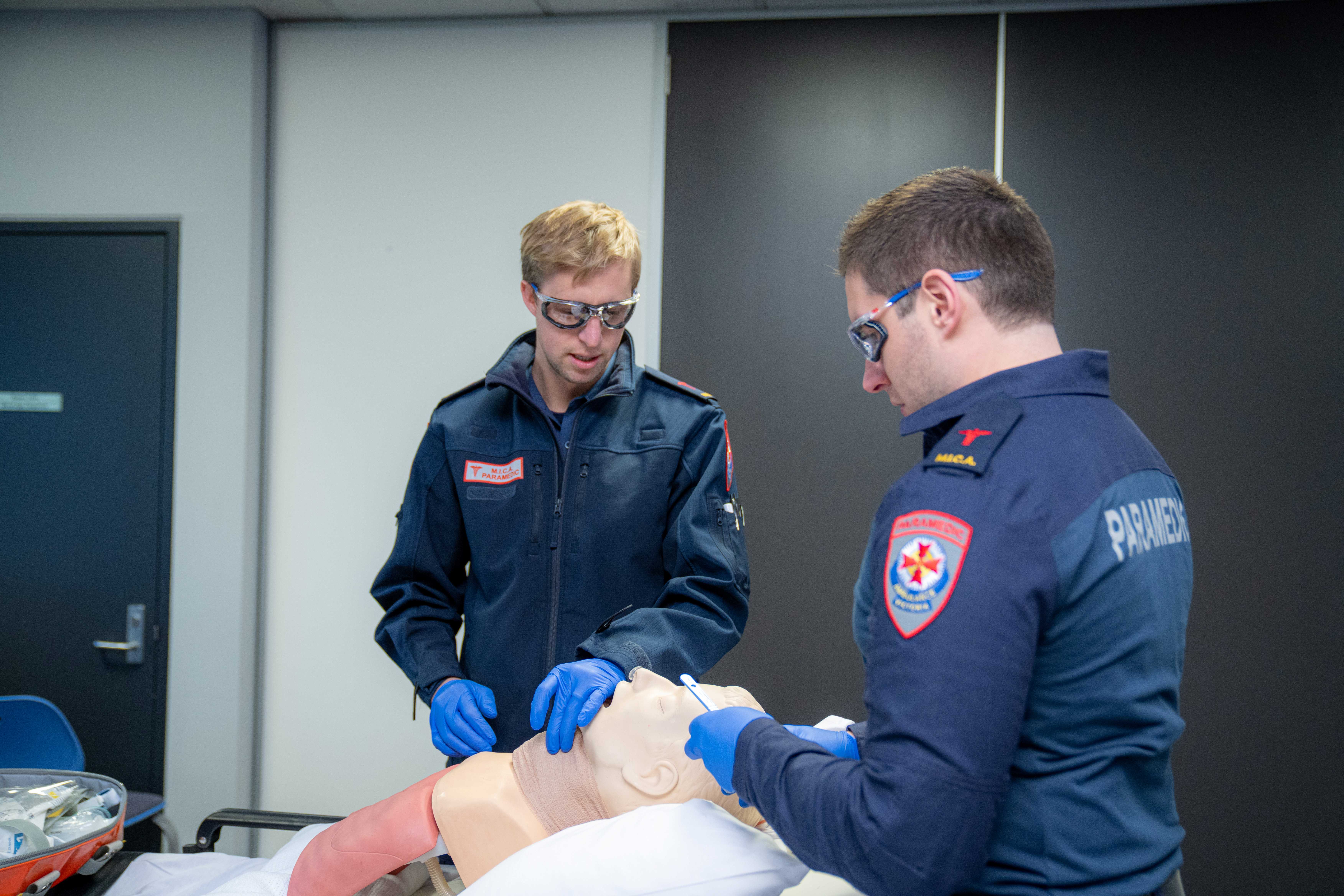 Two MICA paramedics treat a training manikin.