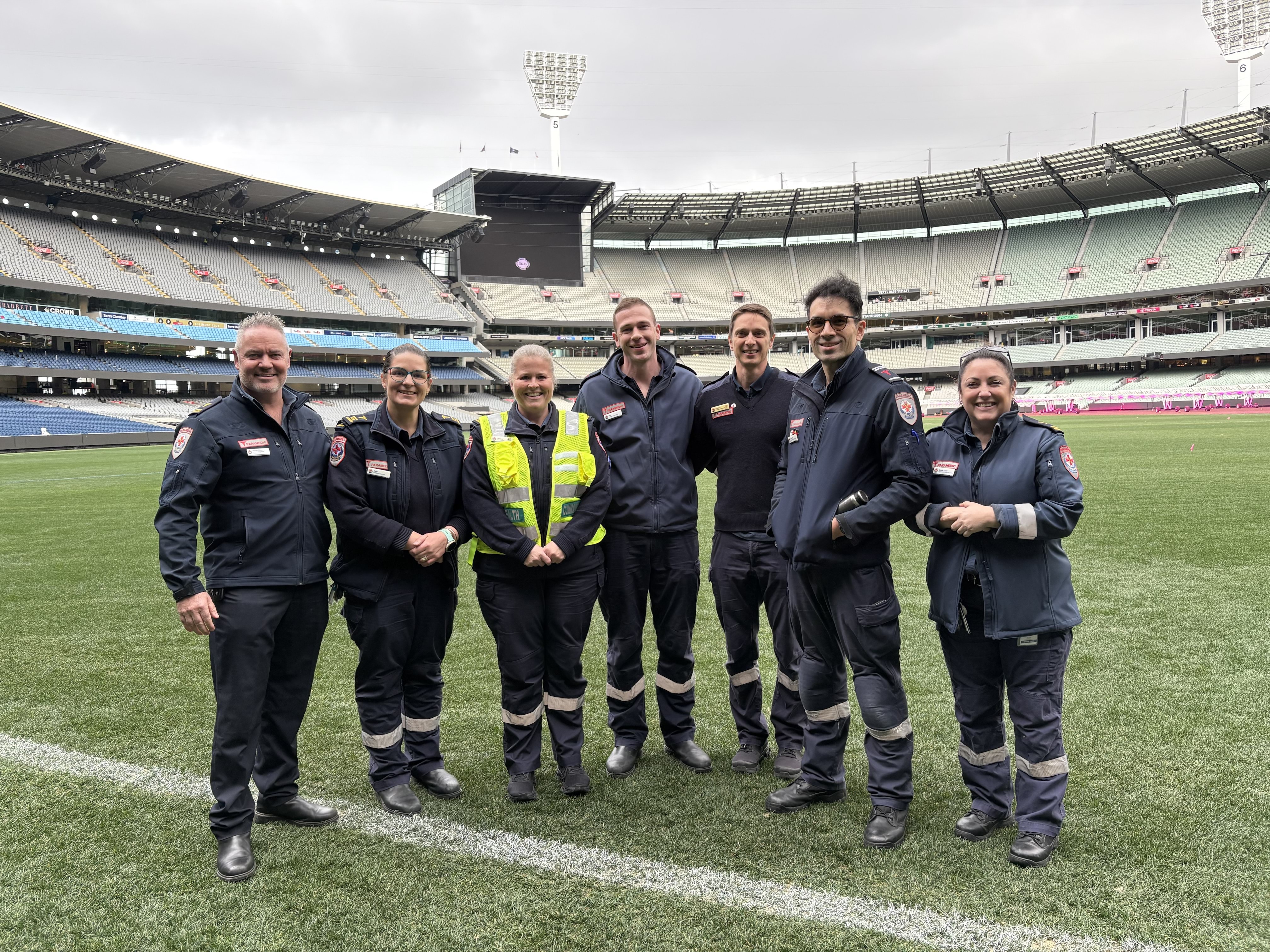 Ambulance Victoria paramedics on the MCG grass.