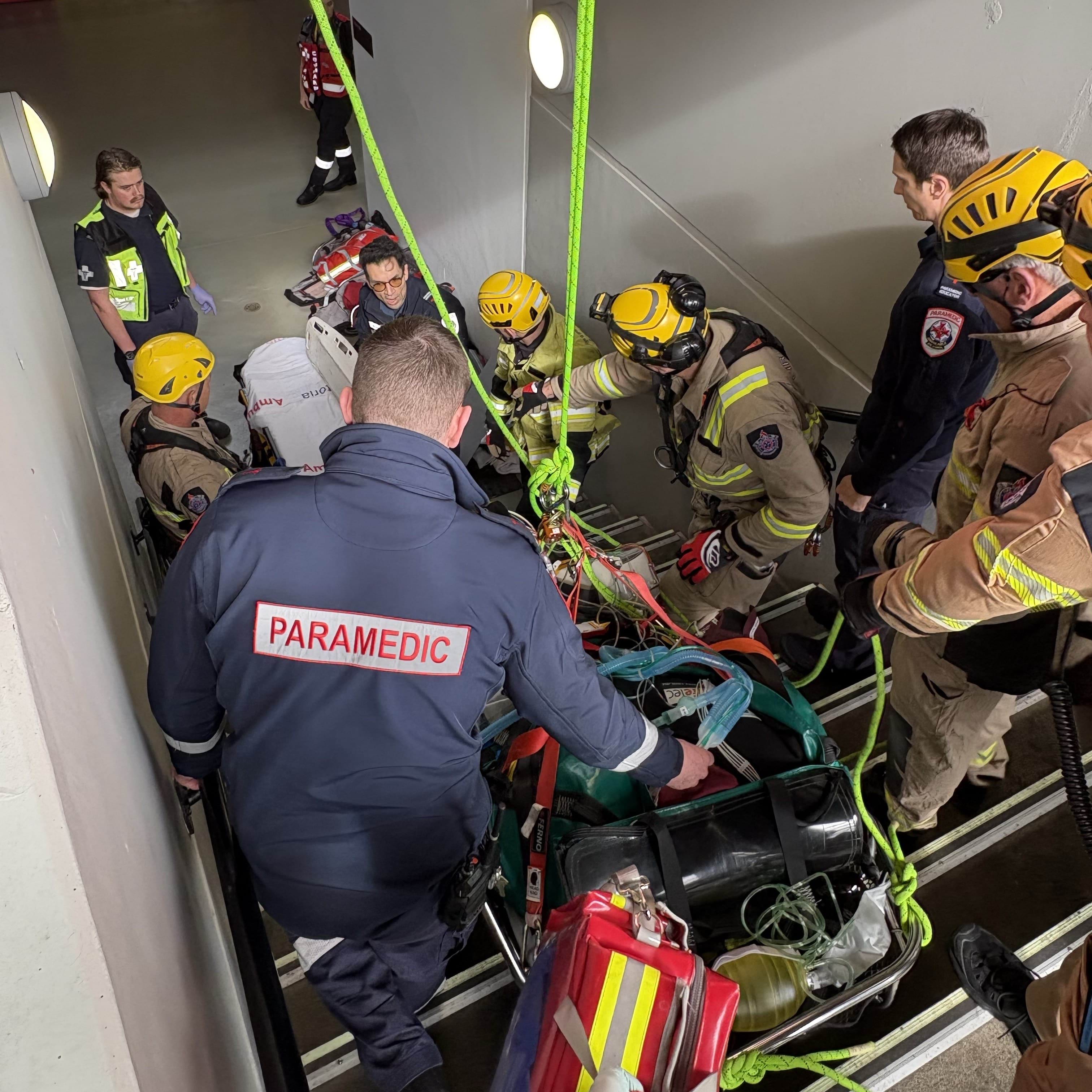Emergency services transport a patient down MCG stairs.