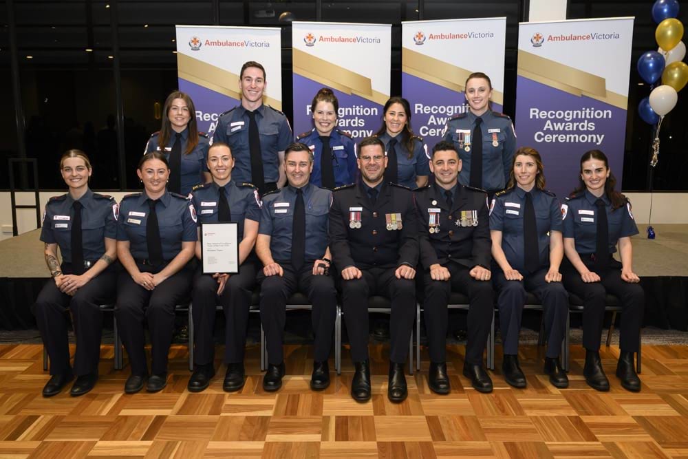 A group photo of paramedics at an awards ceremony.