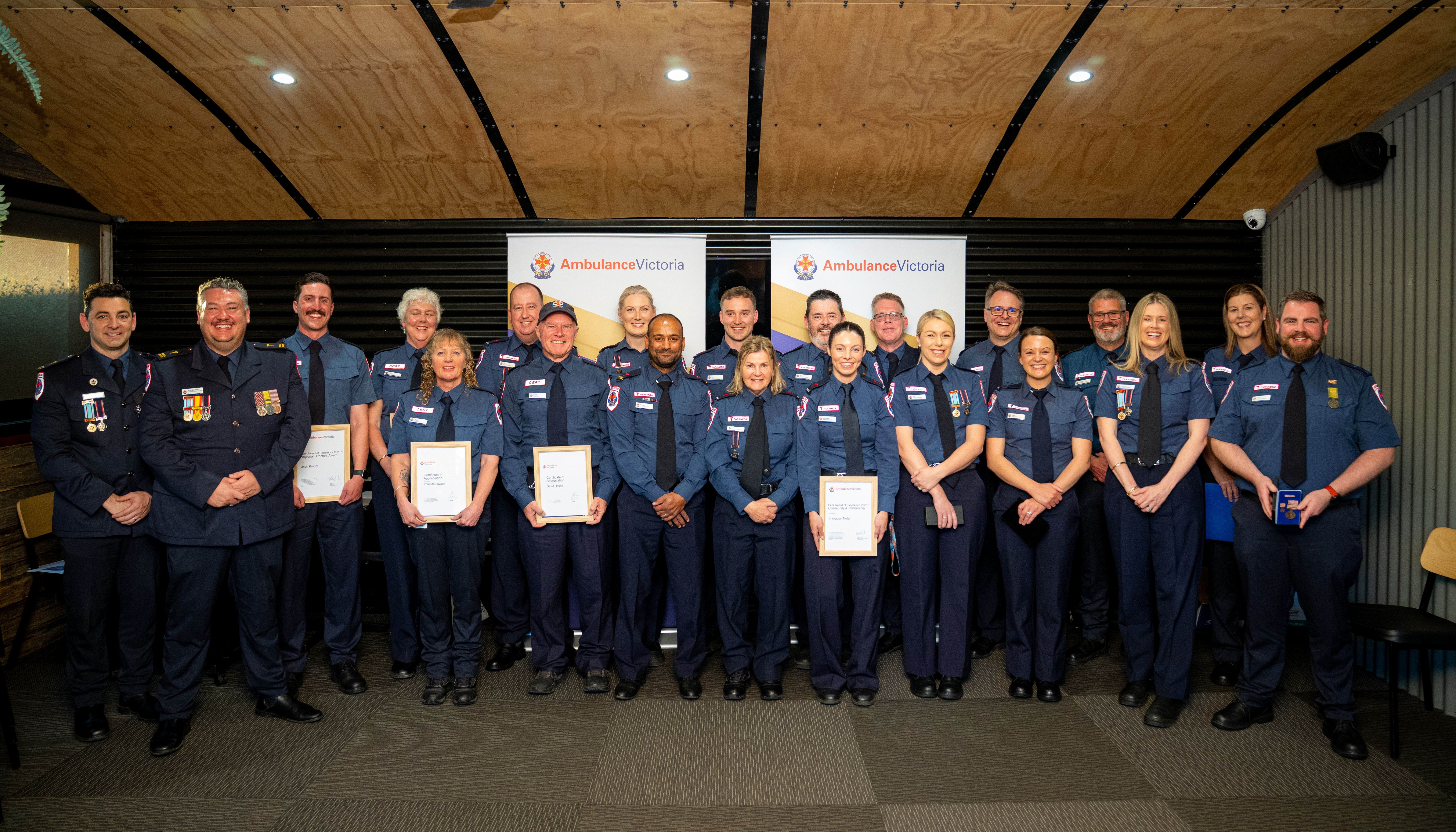 A group photo of Ambulance Victoria staff in dress uniform.