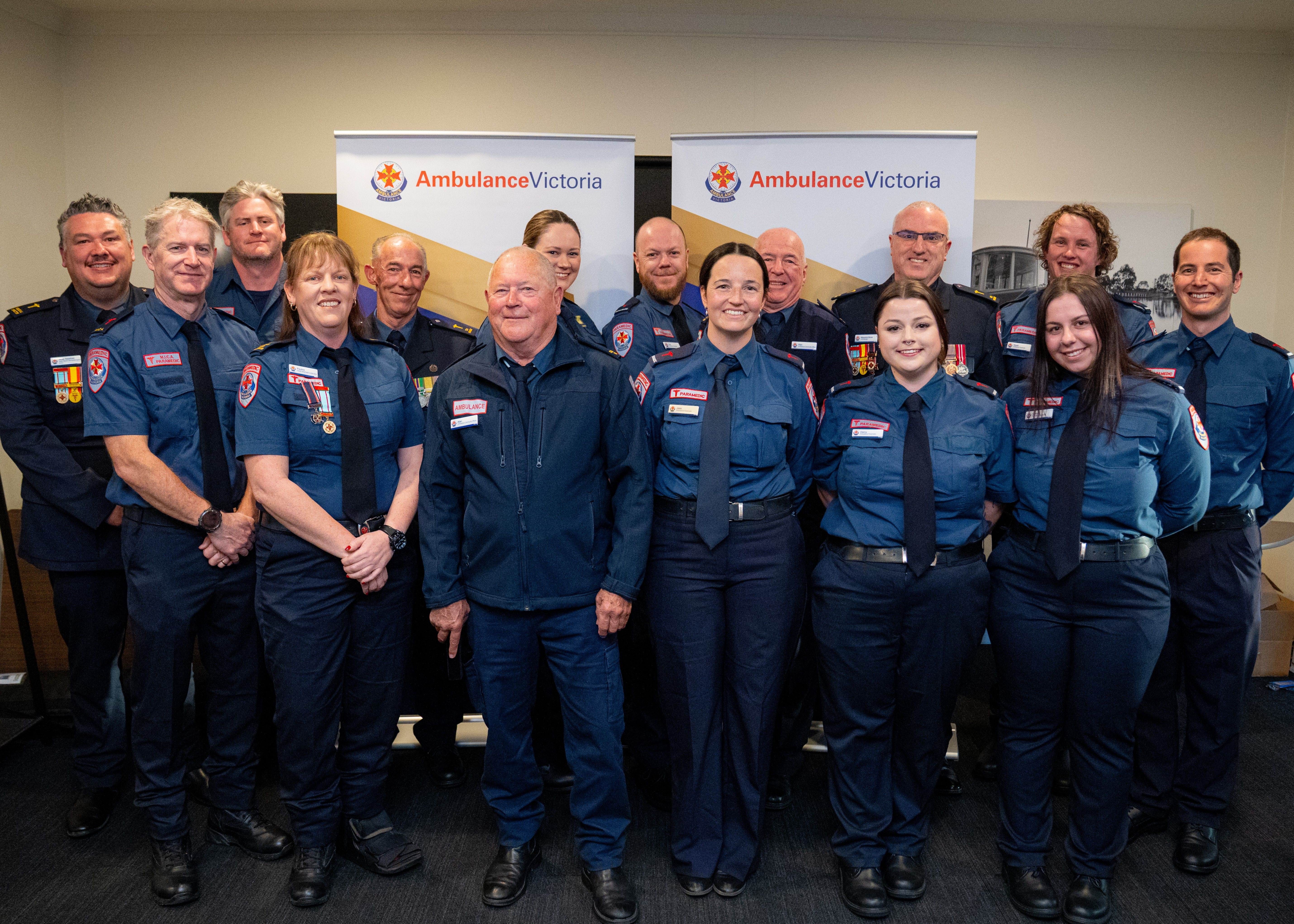 A group photo of Ambulance Victoria staff in dress uniform.