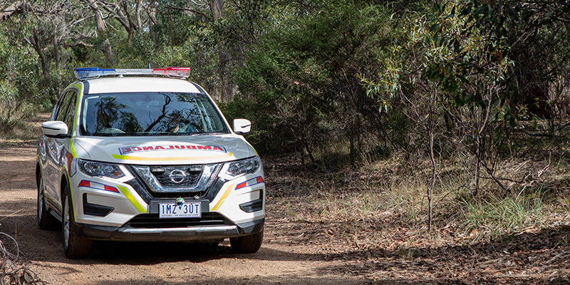 An Ambulance Victoria vehicle driving through the bush in the Victorian outdoors