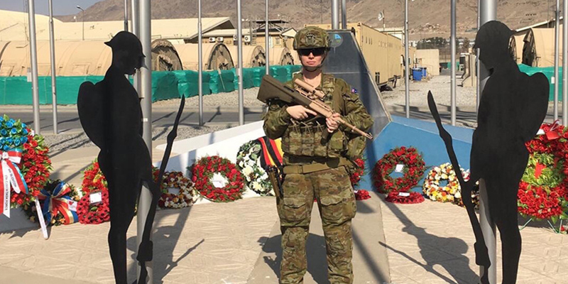 Paramedic and former Army Reserve Medic Melanie Kruse standing in from of a memorial.