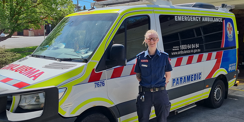 Paramedic and former Army Reserve Medic Melanie Kruse standing beside an ambulance.