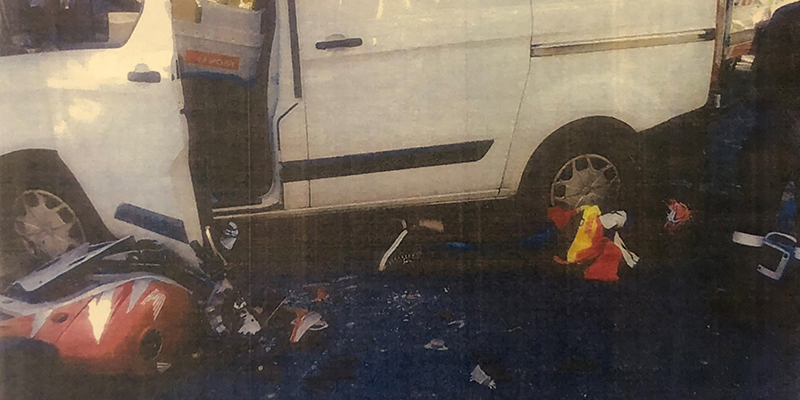 The wreckage of the motorbike Astrid was riding on with the debris scattered all over the road and under the minivan.