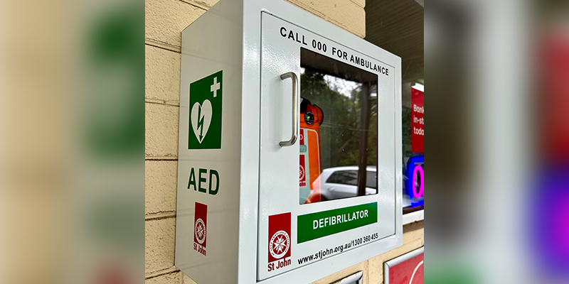 A newly installed automated external defibrillator (AED) on the exterior wall of a general store in Kinglake West.
