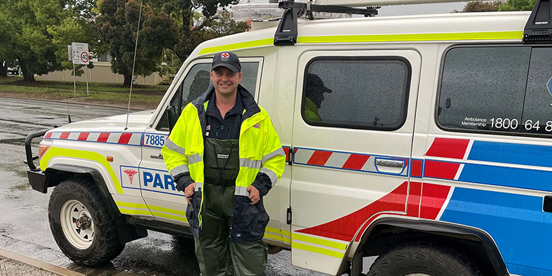 AV Paramedic Educator Adrian Pensak dressed in his waders and standing by the side of his rescue vehicle.