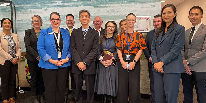 Delegations from both Ambulance Victoria and Singapore Civil Defence Force standing together for a group shot.