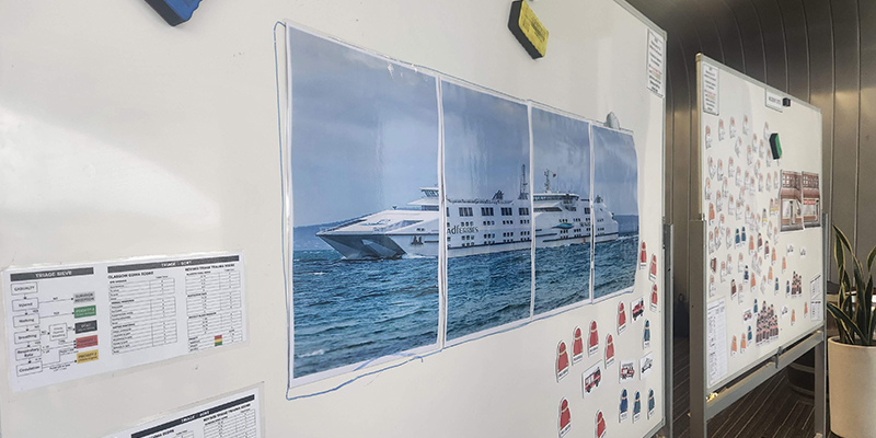 Photo of a ferry pasted on a white board.