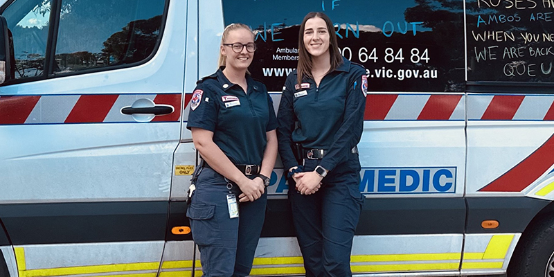 Mildura paramedics Carli Callahan and Meg McQueen are standing beside an ambulance.